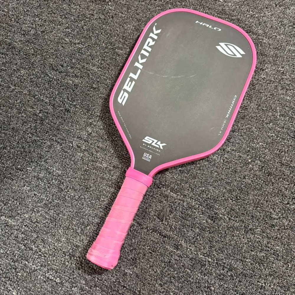 Used pink Selkirk pickleball paddle